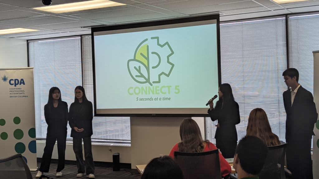 A team presenting their business pitch, "Connect 5," during the JA Company Program summer camp competition, hosted at CPA BC.